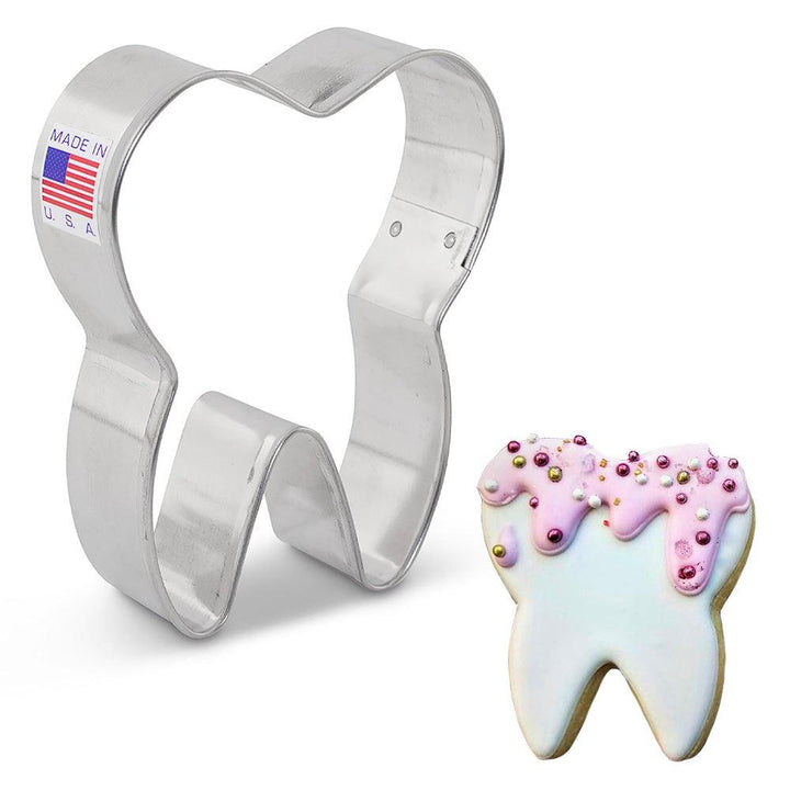 a tooth cookie cutter with a decorated cookie by ann clark